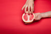 Grapefruit touched by hand