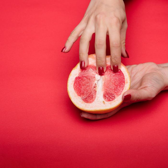 Grapefruit touched by hand