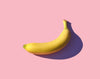 Yellow banana in pink background